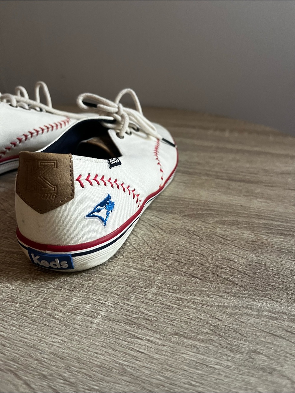 Keds Men's White Canvas Lace-Up Sneakers with Red Stitch Detail/Blue Jays Logo
